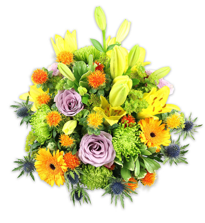 Presented on a white background that lets every hue pop, this vibrant, tightly arranged bouquet balances exuberance with refined craftsmanship. Radiant yellow Asiatic lilies take prominence, their broad petals - some open and freckled, others tucked as elongated buds - introducing movement and a bright, warm focal line. Two soft lavender roses occupy the central plane, their petals curling inward with a velvet softness that cools the composition and invites close, quiet appreciation. Cheerful orange Gerbera daisies provide bold, flat-petaled punctuation, while plentiful lime-green 'button' chrysanthemums add a dense, ruffled texture that feels almost tactile when viewed up close. Tiny, spherical orange and golden-yellow accent flowers appear like confetti across the arrangement, offering pops of concentrated colour and playful dimension. Several blue-grey Eryngium thistles emerge at the perimeter, their star-like, spiky bracts supplying a striking, almost sculptural counterpoint to the rounder blooms. A supporting cast of glossy and matte greens - broad lily leaves, slender fillers, and clustered foliage - knits the bouquet into a cohesive, abundant form and gives the eye places to rest between colour shifts. The soft studio lighting reveals delicate veining and satiny petal finishes, and the implied scent is a gentle blend of lily sweetness and rose powder. Suited to celebrations, get-well wishes, or as an elegant sympathy gesture, this arrangement would brighten a dining room table near Kennington Park or a reception desk by the historic Oval, and its seasonally fresh character is ideal for local delivery within Kennington and neighbouring Vauxhall.